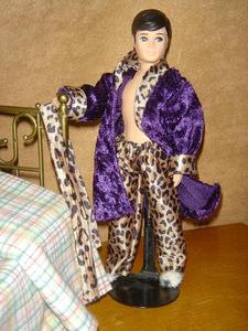Lounge Leopard
Crushed purple velvet robe trimmed in leopard-print satin with matching belt and pajama bottoms. Leopard-print faux-fur slippers.
