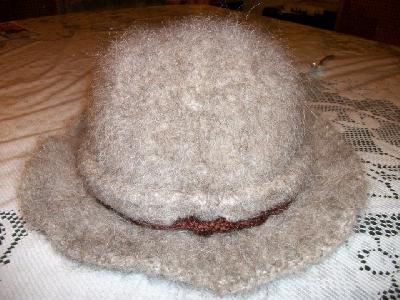 back of the hat
<p>this is where the acrylic i-cord comes out of either side.&nbsp; I had to make it long enough to get from one side to the other before the hat was felted.&nbsp; Ergo, it's really long when the hat felts.</p>
