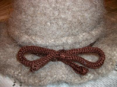 Close up front
<p>In order to take up the slack on the i-cord, I wrapped it around the hat and tied it in a bow.</p>
