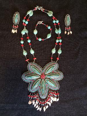 SW Dreams
<p>This set was a finalist in the 2009 Fire Mountain Gems Seed Bead contest. Turquoise cabochons with seed beads, red coral and silver leaves with a turquoise and silver toggle clasp. The earrings are post-back.</p>
